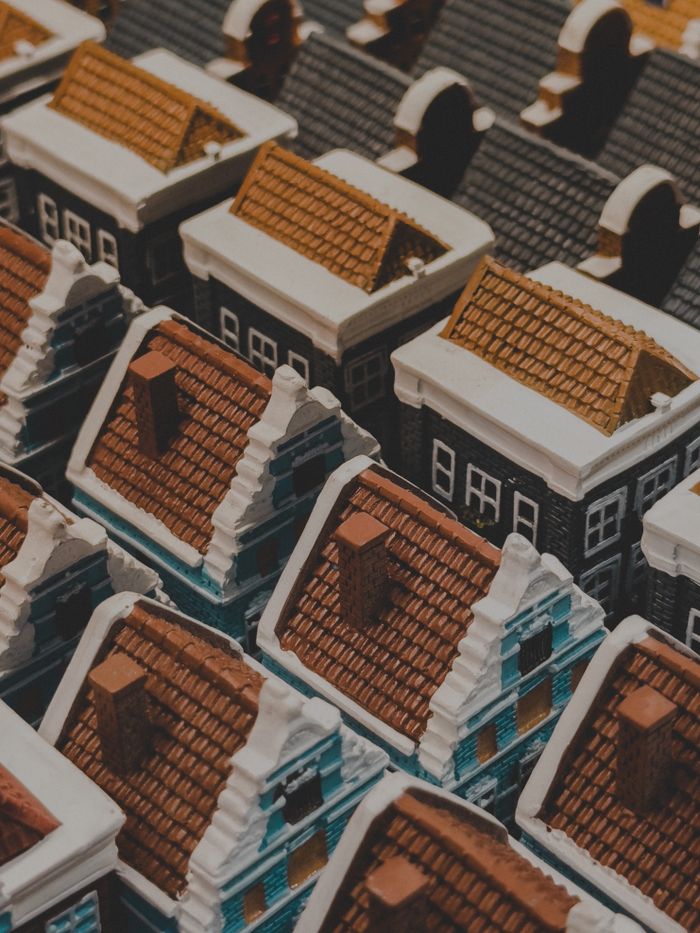 About High-angle shot of intricately detailed miniature model houses with classic European architecture.
